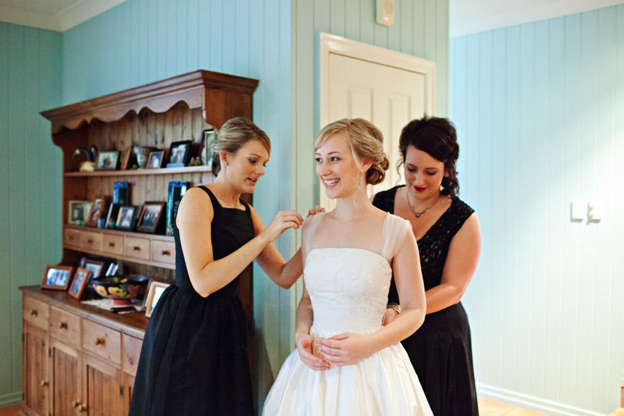 bride putting on gown